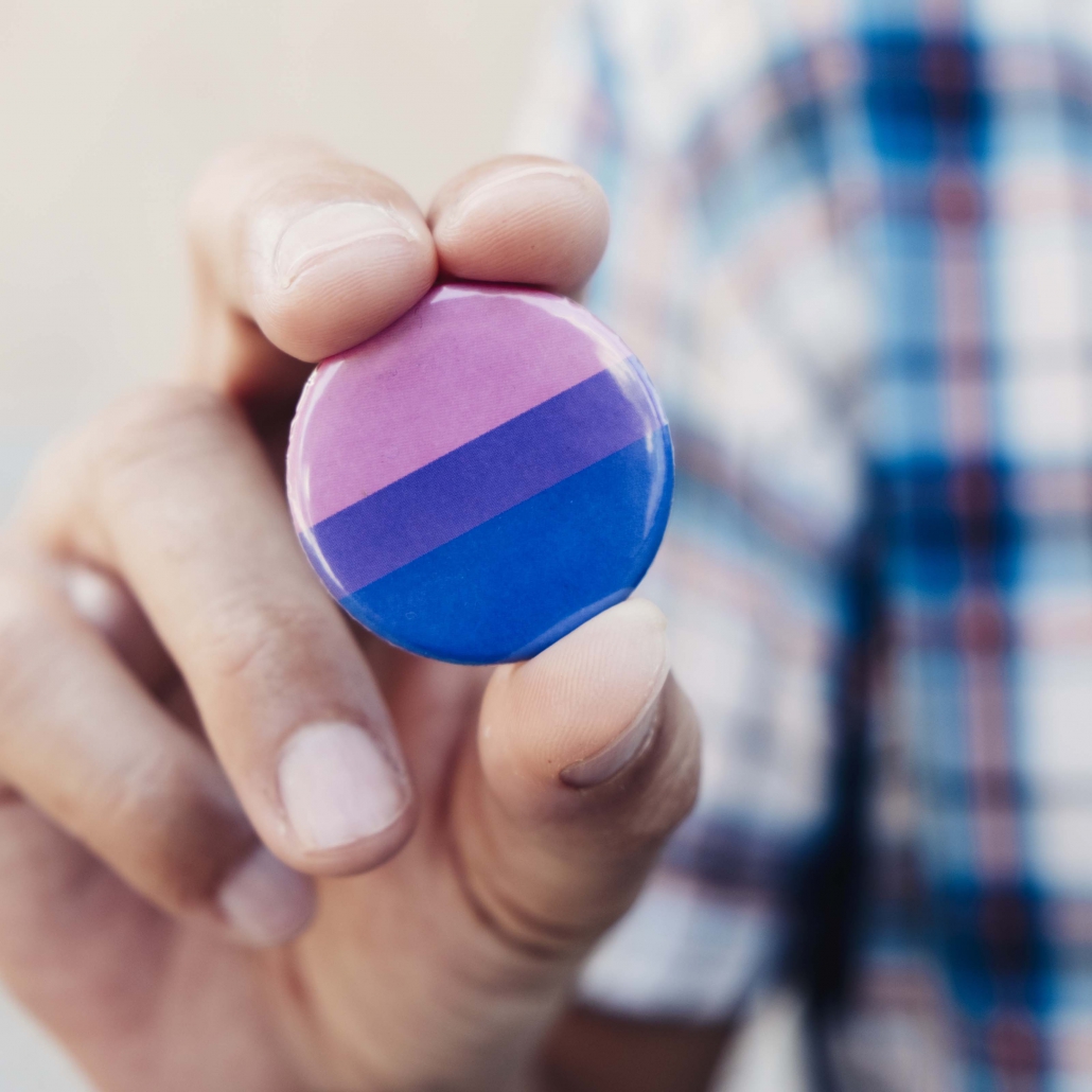 man with a bisexual pride flag badge